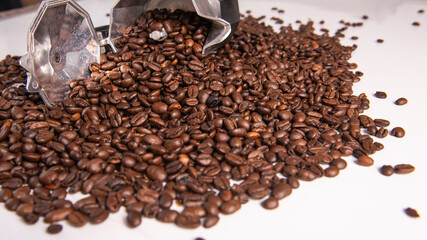 coffee beans woke up from the moka pot to the white table