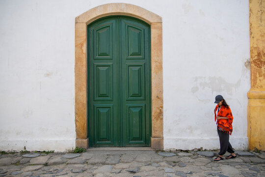 woman walking through the streets of Paraty in Brazil