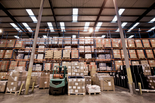 forklift truck parked at fully stocked warehouse in London