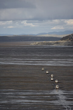 SUV's crossing glacier wetlands on G&Ecirc;savatnalei in central Iceland