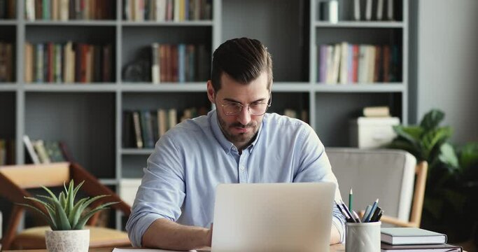 Thoughtful young businessman looking away, considering risks. Focused software developer programmer finding problem solution, writing code on computer. Concentrated manager analyzing market online.