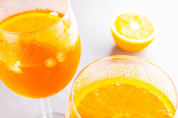 Aperol spritz cocktail on a gray background. Two glasses of aperol spritz with orange slised. Summer cocktail in glass. Top view. Copy space