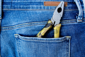 Background with tools in the pocket of blue jeans. Give dad a present. Happy fathers day concept.