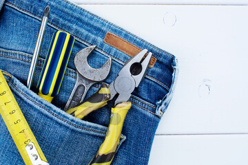 Background with tools in the pocket of blue jeans. Give dad a present. Happy fathers day concept.
