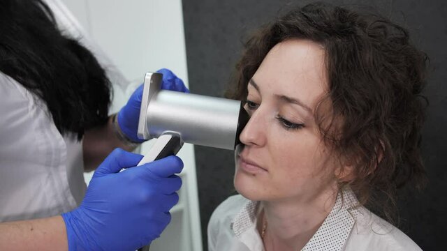 Close up view of dermatovenereologist analyzes the mole in a cosmetology clinic, dermatooncologist.