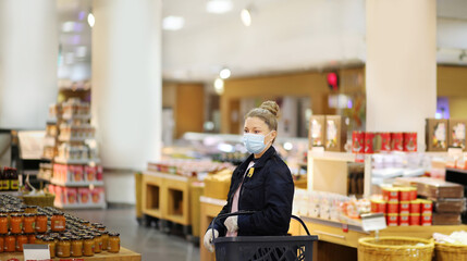 supermarket shopping, face mask and gloves,Woman choosing a dairy products at supermarket	