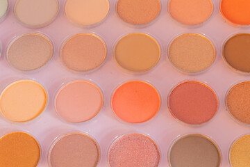 close up and top view of an eye shadow palette of many colors