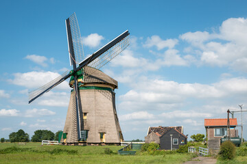 Fototapeta na wymiar Traditional Dutch windmill with pumping house