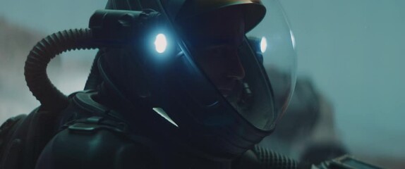 Caucasian male astronaunt checking hud on her suit while exploring planet surface, Mars colonization concept