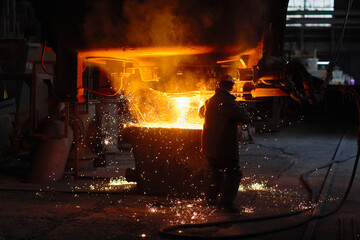 Steelmaker at ingot casting. Electric arc furnace shop EAF. Metallurgy.