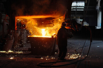 Steelmaker at ingot casting. Electric arc furnace shop EAF. Metallurgy.