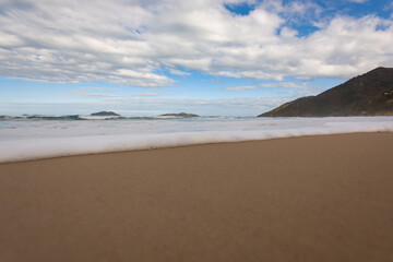 end of wave in the sand, with white foam
