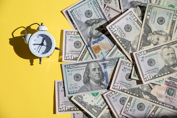 alarm clock and US Banknotes. Car loan, Financial, saving money, insurance and leasing time concepts.Time to pay up.time to pay your bills.money growing concept