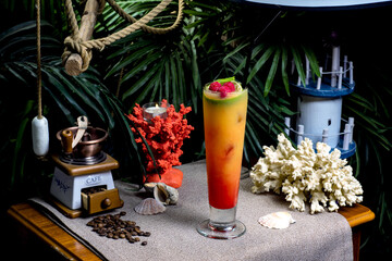beautiful exotic cocktail with fruits on a beach background