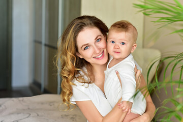 Mother and baby playing and smiling. Happy family.Home interior.