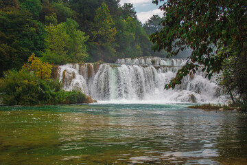 Fototapeta premium Krka National Park. Waterfall and wild landscape at famous tourist attraction in Croatia