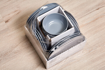 Torn packaging with ceramic cookware.