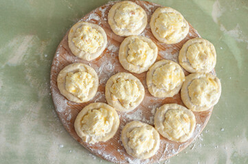 View from the top. Raw pies with cottage cheese goth of the oat to the pastry.