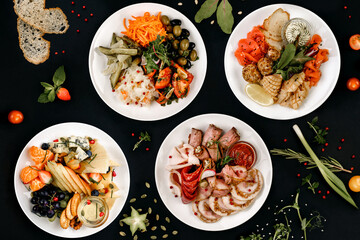 healthy tasty food on a white plate lies on a black background.