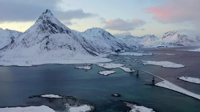 4k drone flight moving to the side footage (Ultra High Definition). Fabulous winter sunrise on Lofoten Islands archipelago, Norway, Europe. Colorful morning view of Fredvang bridge.