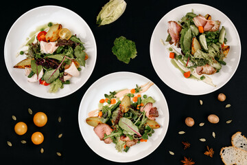 healthy tasty food on a white plate lies on a black background.