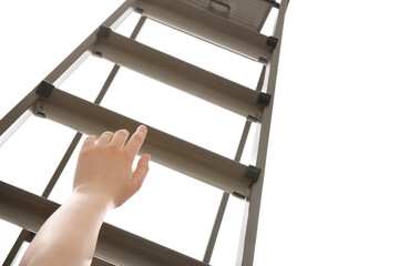 Woman climbing up stepladder against white background, closeup