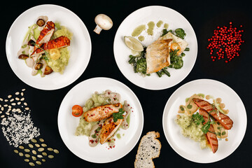 healthy tasty food on a white plate lies on a black background.
