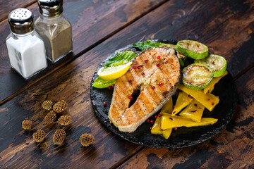 tasty fish food with cheese on wood background