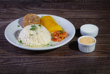 Rice and beans, traditional brazilian dish with manioc and salad.