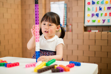 toddler girl play number blocks for homeschooling
