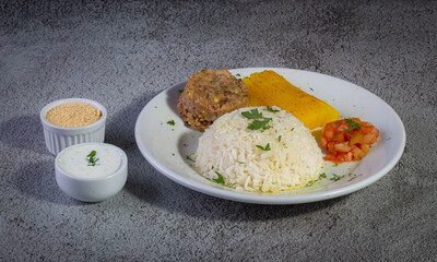 Rice and beans, traditional brazilian dish with manioc and salad.