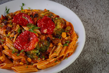 Penne pasta with tomato sauce and vegetables