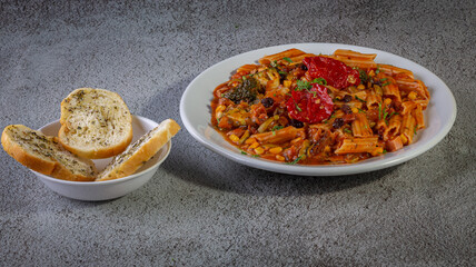 Penne pasta with tomato sauce and vegetables