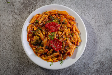 Penne pasta with tomato sauce and vegetables