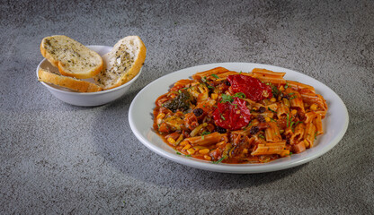 Penne pasta with tomato sauce and vegetables