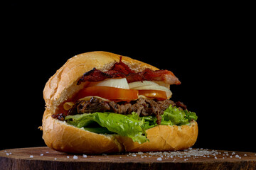 Big homemade sandwich with beef, lettuce, tomato, onion and cheese. Brazilian style