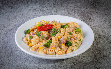 Penne pasta with bechamel sauce and vegetables