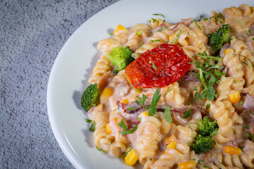 Penne pasta with bechamel sauce and vegetables