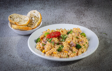 Penne pasta with bechamel sauce and vegetables