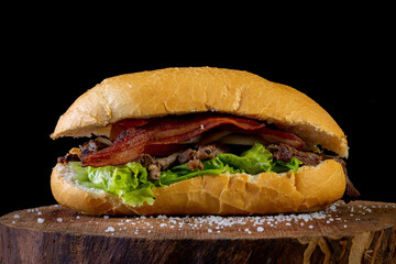 Big homemade sandwich with beef, lettuce, tomato, onion and cheese. Brazilian style