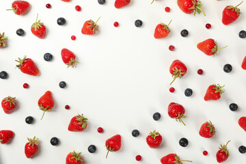 Flat lay with tasty strawberry and blueberry on white background, top view. Summer berry