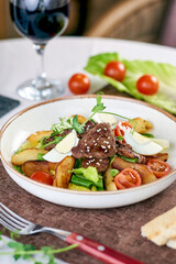 healthy salad lies in white plate