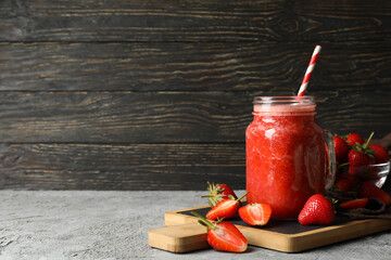 Composition with strawberry cocktail on gray table. Summer berry