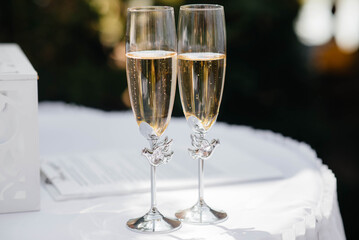Beautiful decorated holiday glasses with champagne close-up. Holiday glasses