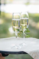 Beautiful decorated holiday glasses with champagne close-up. Holiday glasses