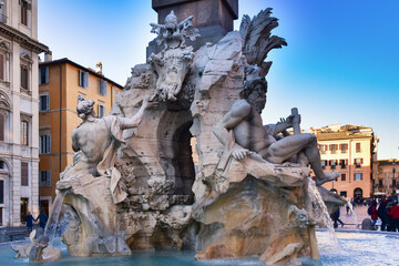 Fototapeta na wymiar Fountain of the Four Rivers on Piazza Navona. Ancient fountain, statues, obelisk design of Bernini. Famous landmark touristic location near Sant Agnese in Agone church in Rome, Italy