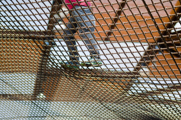 building with a floor that allows people to walk in a vacuum thanks to a net made of steel ropes...