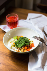 Salad bowl with sauce, basil and tomato