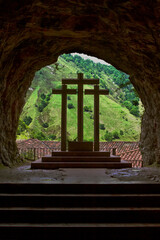 Entrance to cave guarded by religious symbols