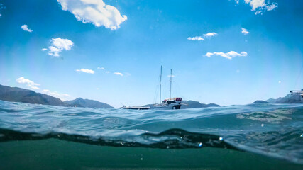Underwater photo of beautiful yacht floating in the sea